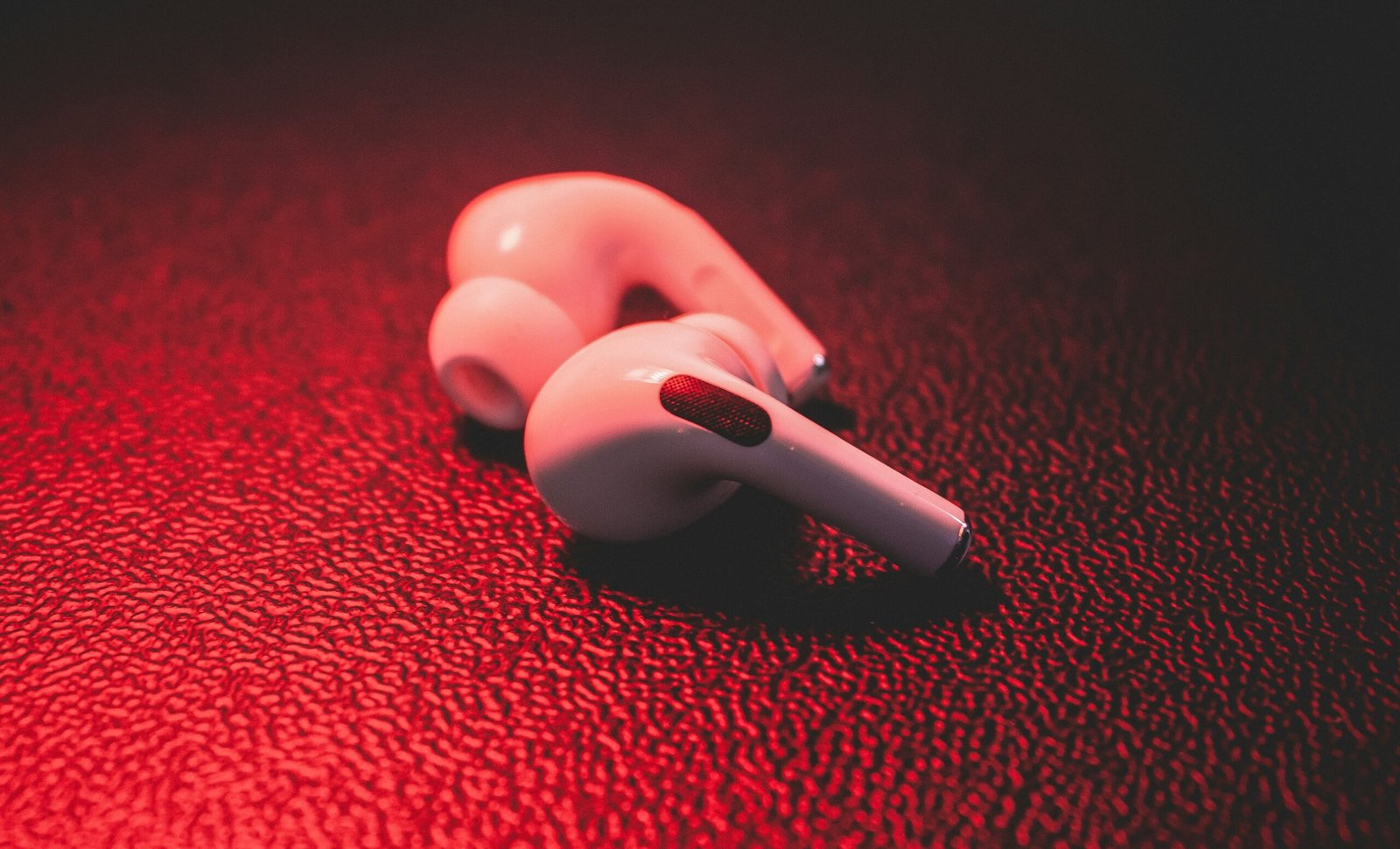 red plastic toy on red textile